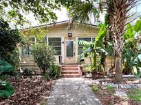 Charming single-story home featuring lush tropical landscaping and a welcoming front porch at 803 E Amelia St, Orlando, FL 32803