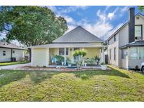 Charming single-Gathering home with a gabled roof and a lovely front porch, set against a bright sky and lush greenery at 1110 Virginia Ave, St Cloud, FL 34769