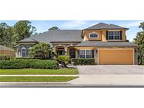 Charming home featuring stone accents, manicured landscaping, and an attached two-car garage at 3418 Turningwind Ln, Winter Garden, FL 34787