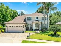 Charming two-story home with a brick driveway, well-manicured lawn, and lush landscaping at 772 Pickfair Ter, Lake Mary, FL 32746