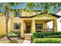 Charming two-story home with a welcoming front porch, green shutters, and stone accents at 7809 Purple Finch St, Winter Garden, FL 34787