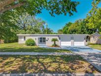 Charming single-story home featuring a well-manicured lawn, and two-car garage at 1228 Vantage Dr, Orlando, FL 32806