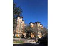 Elegant multi-story condominium building with a unique architectural design, lovely landscaping, and convenient parking at 12527 Floridays Resort Dr # 311E, Orlando, FL 32821