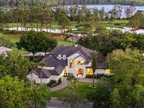 Stunning aerial view of the home, showcasing its proximity to the golf course and lake at 9508 Sloane St, Orlando, FL 32827