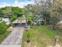 Charming single-story home with carport, palm trees, water fountain, and basketball hoop at 3407 Silverwood Dr, Orlando, FL 32808