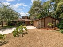 Charming single-story home featuring a combination of wood and stone facade, with a well-manicured front yard at 490 Burnt Tree Ln, Apopka, FL 32712