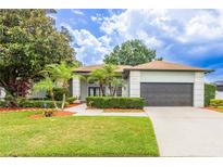Charming single-Gathering home with lush landscaping and a well-manicured lawn at 8023 Canyon Lake Cir, Orlando, FL 32835