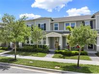Charming two-story townhome with a welcoming front porch and well-maintained landscaping at 16217 Prairie School Dr, Winter Garden, FL 34787