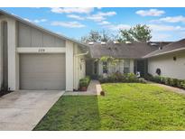Charming single-story home featuring a well-manicured lawn and attached garage with a private residential street view at 239 Hill St # 239, Casselberry, FL 32707