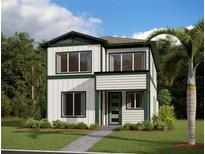 Charming two-story home featuring a modern design with white siding, green trim, and lush landscaping at 2980 Embark Trail, St Cloud, FL 34771