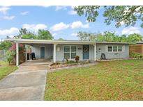 Charming single-story home with a carport, landscaped yard, and inviting curb appeal at 3631 Surrey Dr, Orlando, FL 32812