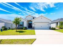 Charming single-story home featuring a manicured front lawn and a two-car garage, creating inviting curb appeal at 4231 Swan St, Haines City, FL 33844