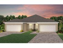 Charming one-story home featuring a two-car garage, a well-manicured lawn, and lovely landscaping at 6324 Dew Drop Loop, St Cloud, FL 34771