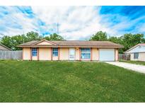 Charming single-story home with a well-maintained lawn and attached one car garage at 855 Third St, Orange City, FL 32763