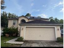 Charming two-story home featuring a two-car garage and solar panels on the roof at 1632 Cornerview Ln, Orlando, FL 32820