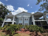 Inviting condo exterior showcasing dual balconies and lush landscaping, perfect for relaxing outdoors at 2608 Grassy Point Dr # 102, Lake Mary, FL 32746