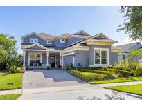 Charming two-story home with landscaped yard and paver driveway at 7837 Bostonian Dr, Winter Garden, FL 34787