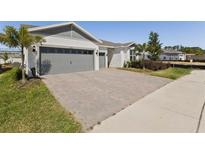 Charming one-story home with a two-car garage and a well-manicured, brick-paved driveway at 15173 Willow Ridge Dr, Montverde, FL 34756