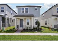 Charming two-story home featuring a covered porch and manicured landscaping at 16484 Silver Brook Way, Winter Garden, FL 34787