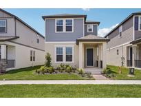 Charming two-story home featuring a beautifully landscaped yard and inviting front porch at 5139 Passion Flower Way, Winter Garden, FL 34787