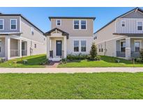 Charming two-story home with a well-manicured front lawn and inviting entryway at 5217 Passion Flower Way, Winter Garden, FL 34787