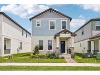 Charming two-story home with blue siding, stone accents, and a well-maintained front yard at 5235 Passion Flower Way, Winter Garden, FL 34787