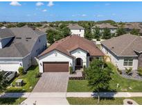 Beautiful single-story home with well-manicured lawn, brick driveway, and attached garage at 12188 Ryegrass Trl, Orlando, FL 32824