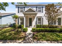Charming two-story home with a well-manicured lawn and garden beds offers an inviting entrance at 14751 Clarkson Dr, Orlando, FL 32828