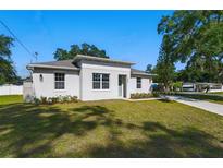 Inviting single-story home featuring a well-manicured lawn and modern architectural details at 1620 Haddock St, St Cloud, FL 34771