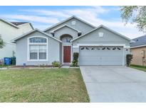 Charming single-Gathering home with a well-maintained lawn and a two-car garage on a sunny day at 2122 Korat Ln, Maitland, FL 32751