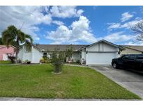 Charming single-story home with a well-maintained lawn, mature landscaping and a two-car garage at 2673 Dixie Ln, Kissimmee, FL 34744