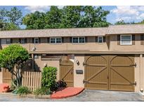 Charming townhouse featuring a well-maintained exterior with a private entrance, brick accents, and attached garage at 3104 Harrison Ave # E-30, Orlando, FL 32804