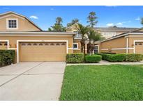 Charming two-story home with well-maintained lawn and landscaping features a large two-car garage at 456 Harbor Winds Ct, Winter Springs, FL 32708