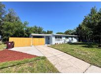 Charming single-story home with a well-maintained lawn, fenced yard, and a long driveway leading to the entrance at 511 S Alder Ave, Orlando, FL 32807