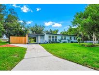 Charming single-story home featuring a well-manicured lawn and a covered entry, exuding curb appeal at 511 S Alder Ave, Orlando, FL 32807