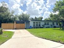 Charming single-story home featuring a well-manicured lawn and inviting front entrance at 511 S Alder Ave, Orlando, FL 32807