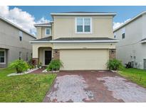 Charming two-story home with brick paver driveway and manicured landscaping at 5248 Royal Point Ave, Kissimmee, FL 34746