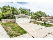 A one car garage, with ample parking space in the driveway, in front of this home at 142 Placid Woods Ct, Sanford, FL 32773