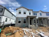 New two-story townhome featuring a modern design under construction with visible structural elements at 15363 Burgtheater Dr, Winter Garden, FL 34787