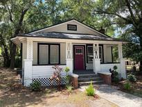 Charming single-story home with a cozy front porch and neatly landscaped yard at 2504 Yale Ave, Sanford, FL 32773