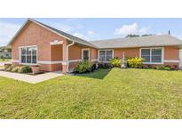 Charming home exterior featuring lush landscaping and a well-maintained lawn at 2945 Juniper Dr, Edgewater, FL 32141