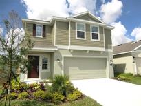 Charming two-story home featuring a spacious two-car garage and beautifully landscaped front yard at 312 Loch Ct, Davenport, FL 33837
