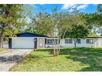Charming single-story home with a well-manicured lawn and mature trees offering curb appeal at 505 Lake Shore Dr, Maitland, FL 32751