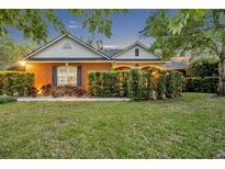 Charming single-story brick home with a well-manicured lawn and mature landscaping at 1130 Roxboro Rd, Longwood, FL 32750