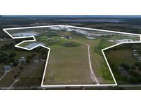Expansive land parcel with a mix of open fields and natural wetlands, enclosed by a white boundary line at 11320 Montevista Rd, Clermont, FL 34711
