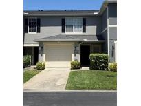 Charming townhome featuring a one-car garage and neat front yard landscaping at 12850 Lexington Summit St, Orlando, FL 32828