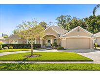 Charming single-story home with well-manicured lawn and inviting curb appeal on a sunny day at 189 Hammock Oak Cir, Debary, FL 32713
