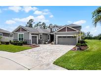 Charming home with a well-maintained lawn, beautiful landscaping, and a stylish driveway at 1910 Donahue Dr, Ocoee, FL 34761