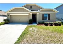 Charming single-story home with a well-manicured lawn and a neutral-colored exterior at 216 Grove Branch Rd, Winter Haven, FL 33880