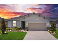 Charming single-story home with a two-car garage and a beautifully landscaped front yard, enhanced by lawn lighting at 2731 Rowan St, Tavares, FL 32778